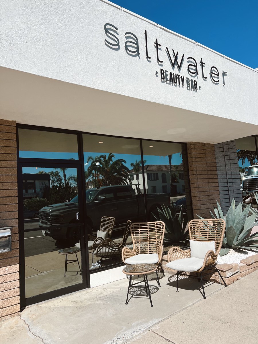 Front entrance of Saltwater Beauty Bar in Capistrano Beach, with the saltwater Beauty Bar sign above the storefront windows